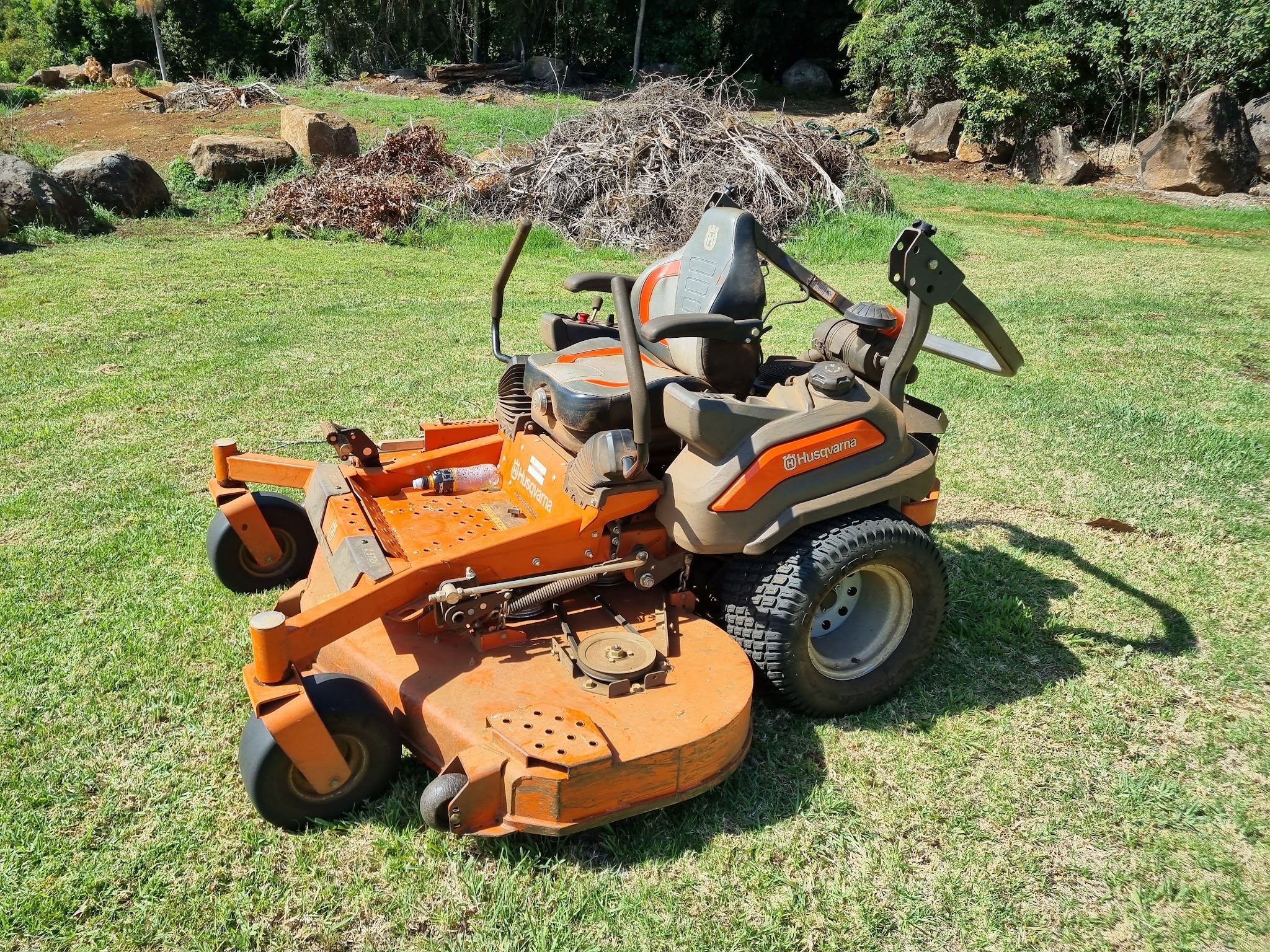 A Husqvarna zero-turn mower on an acreage lawn on Tamborine Mountain